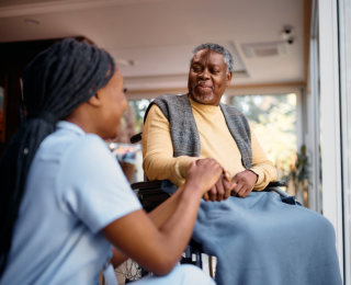 health professional woman with a senior man on a wheelchair