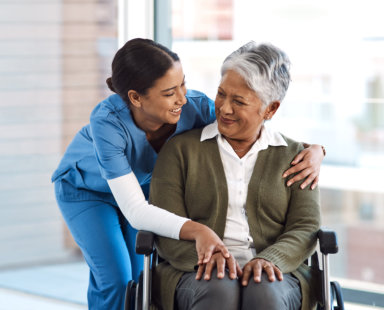 senior woman on wheelchair and a caregiver