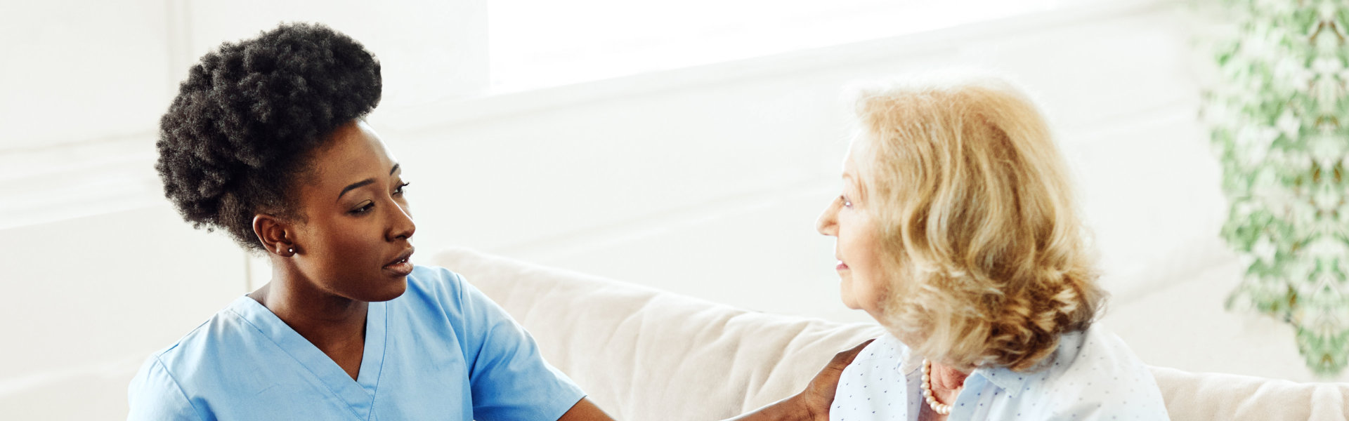 caregiver touching a senior woman