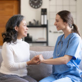 A female and a senior woman looking at each other smiling