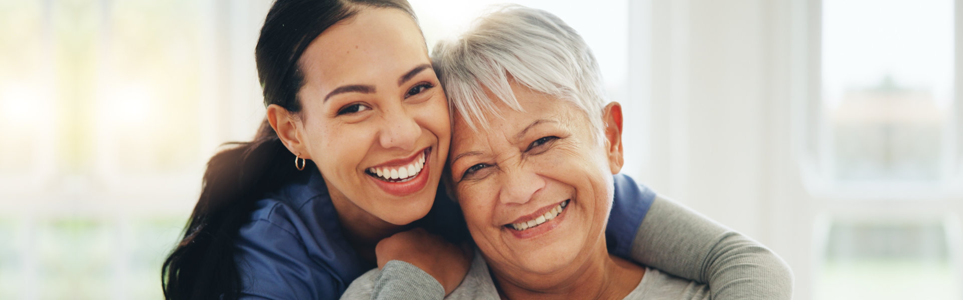 happy woman nurse hug senior patient