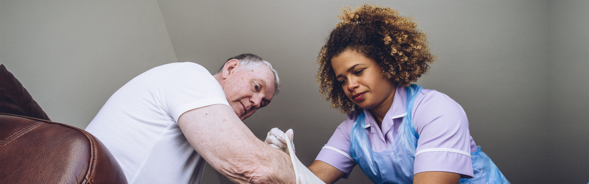 caregiver helps a senior woman